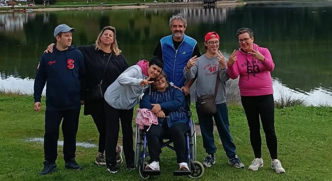 Foto di gruppo dei partecipanti e degli educatori della UET «Il Casale» sulla riva del lago di Auronzo, durante il soggiorno in Cadore.